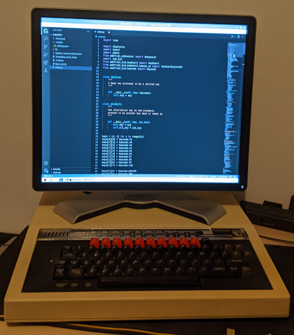 Monitor showing keyboard code, sitting on top of bbc micro keyboard