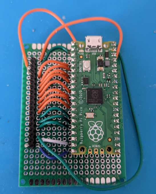 pins for ribbon cable neatly wired to base of raspberry pico circuit board